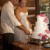 Bride and groom cut cake outside of cabin