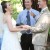 Bride, groom, and officiant laughing
