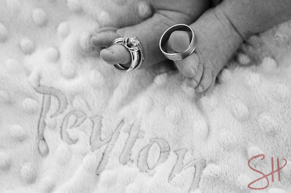 Baby's toes with parents' rings