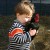 Toddler holding a chicken
