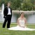 Bride and groom by a pond with a fountain