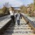 Brother and sister walking down railroad tracks