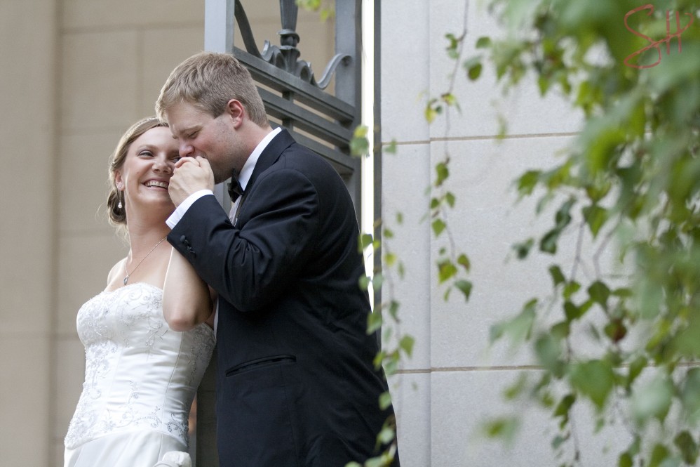 Groom kissing bride's hand